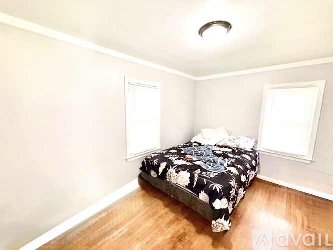 A bedroom with a bed and a window.