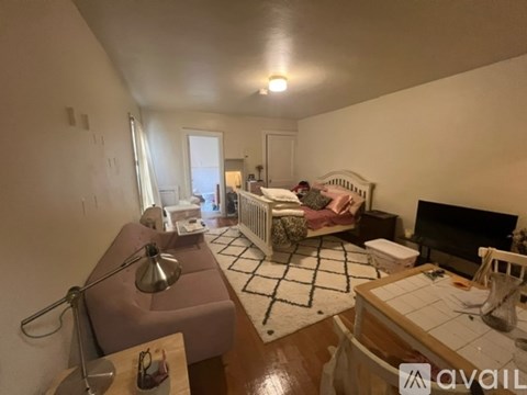 A woman is sitting on a couch in a living room.