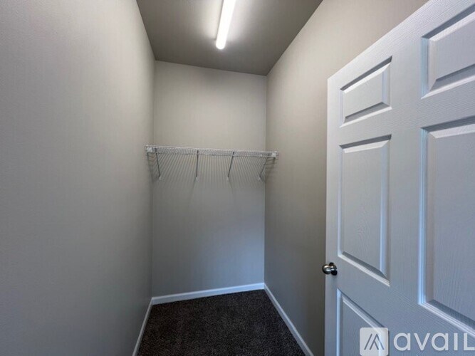 A small, empty room with a door and a shelf.