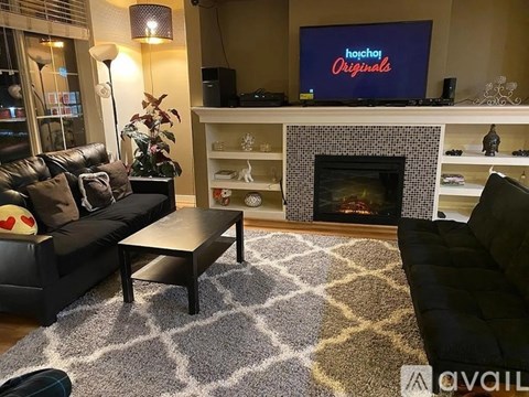 A living room with a fireplace and a television displaying the text "hockey originals".