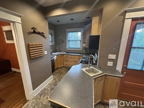 A kitchen with a sink and a window.