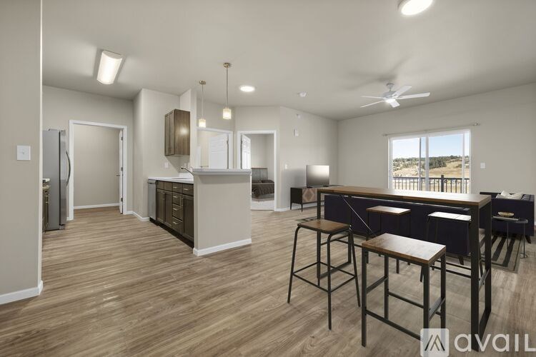 A modern kitchen with a dining table and chairs.