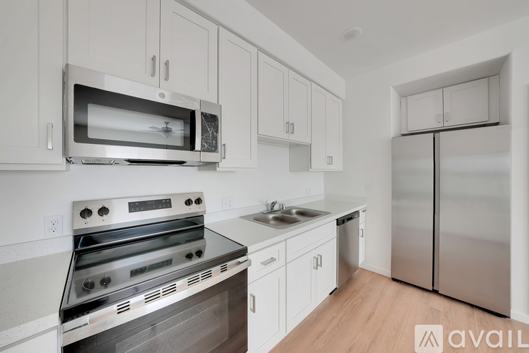 A kitchen with white cabinets and stainless steel appliances.