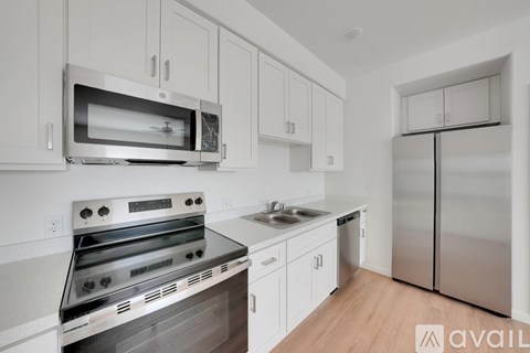 A kitchen with white cabinets and stainless steel appliances.