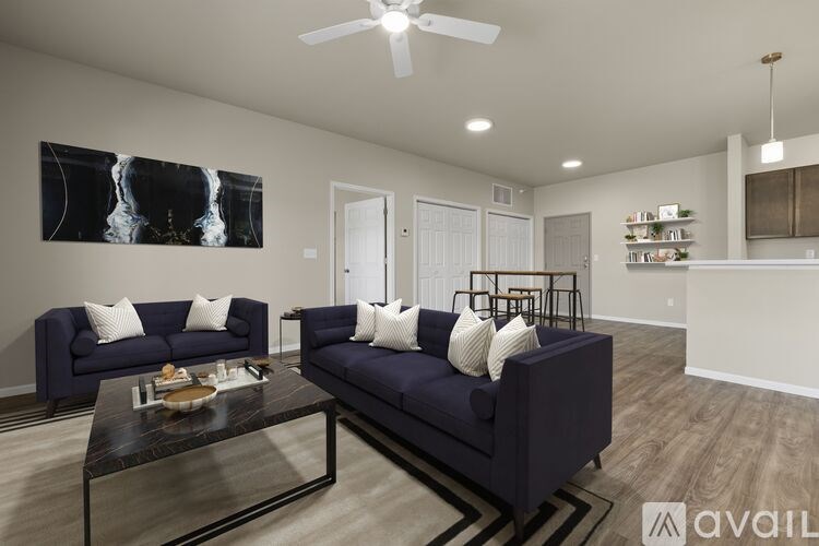 A living room with a dark blue sofa and a coffee table.