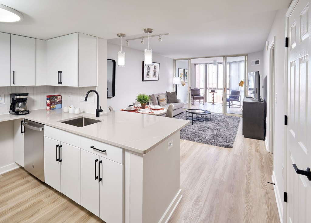 A modern kitchen with white cabinets and a large island.