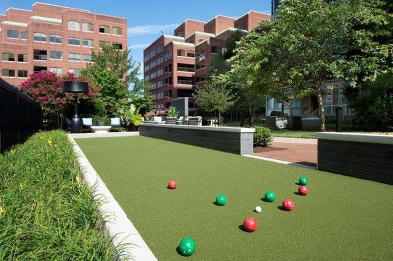 A bocce ball court with red, green, and blue balls.