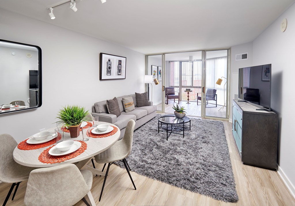A modern dining room with a round table set for two.