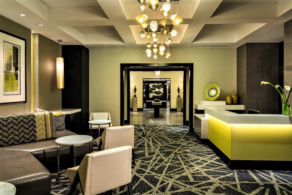 A modern living room with a black and white patterned rug.