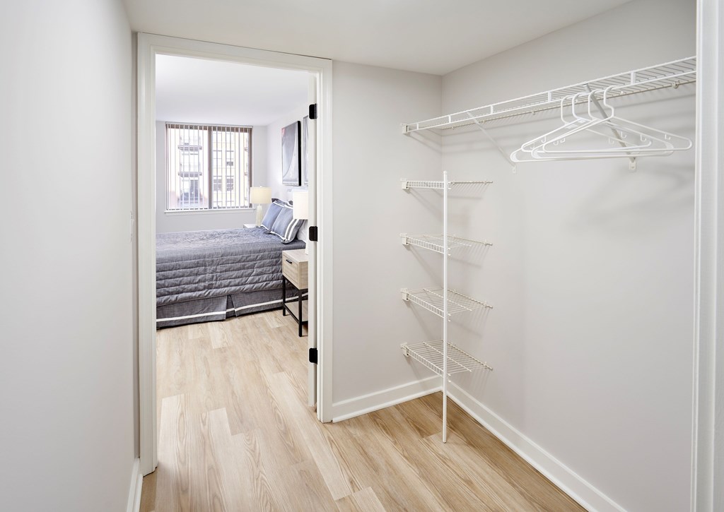 A white closet with a hanging rod and shelves.