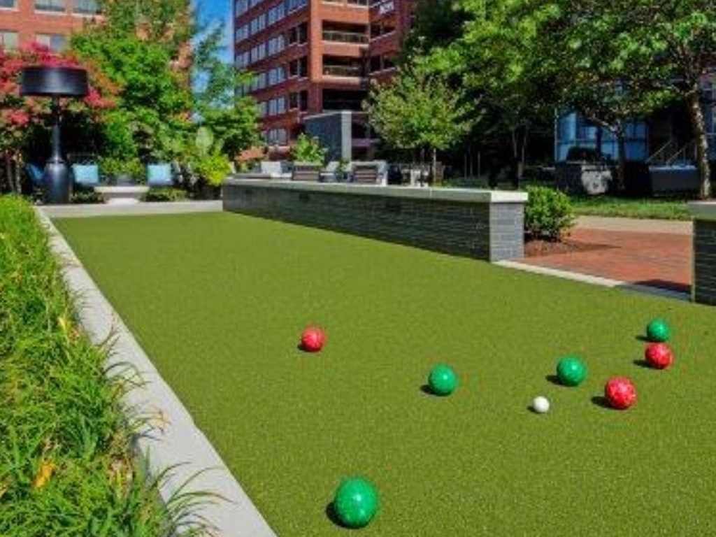 A lawn with green, red, and white balls on it.