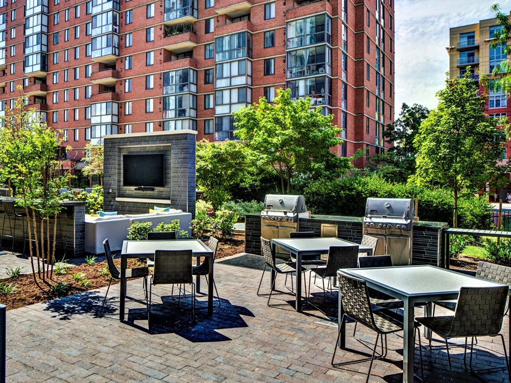 A patio with a table and chairs and a television.