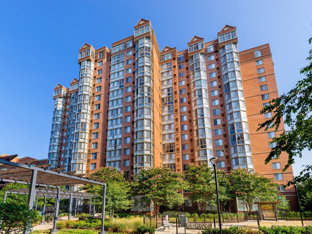 A large, modern apartment building with a mix of brick and glass facades.