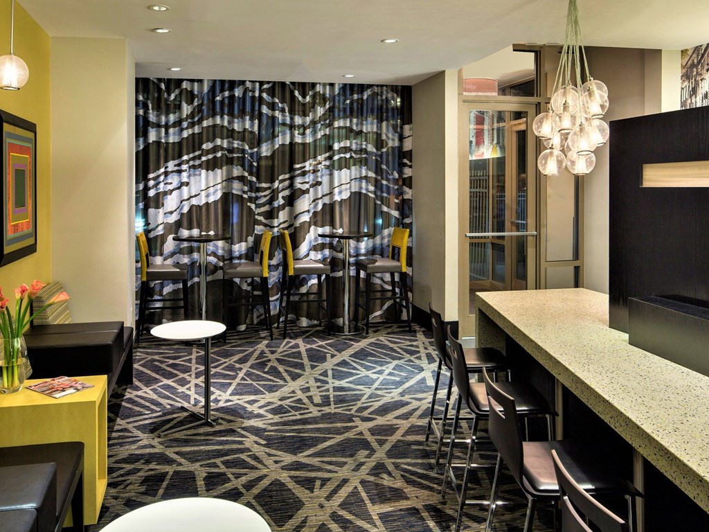 A room with a patterned carpet and a bar area.