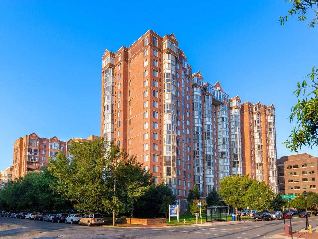 A large red brick building with many windows is in the foreground.