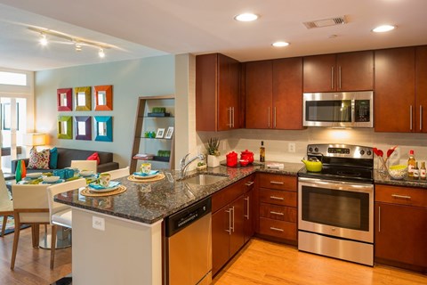 A modern kitchen with wooden cabinets and stainless steel appliances.