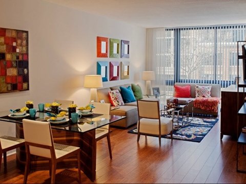 A dining room with a glass table and chairs.