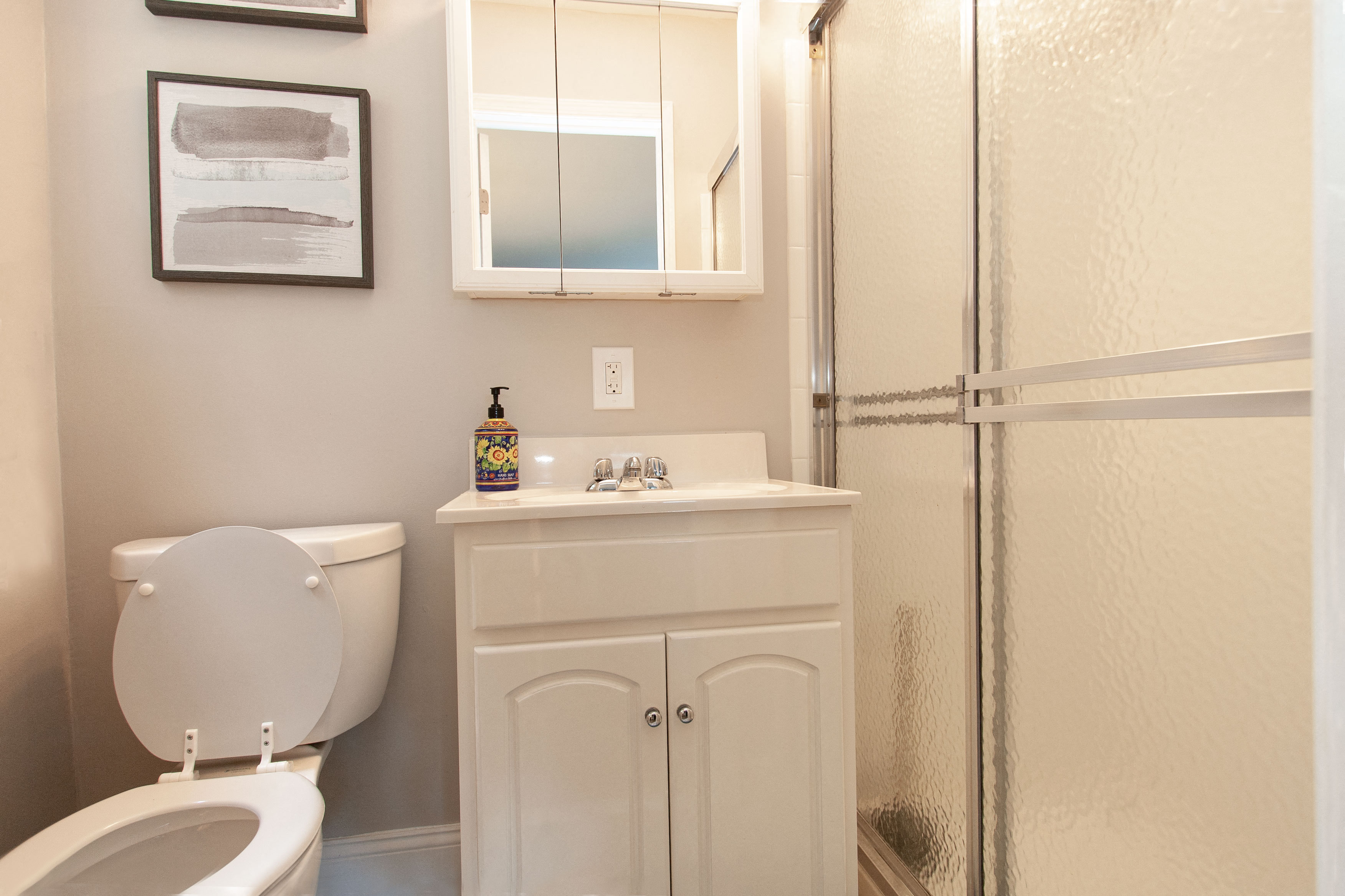 a bathroom with a toilet and a sink and a shower