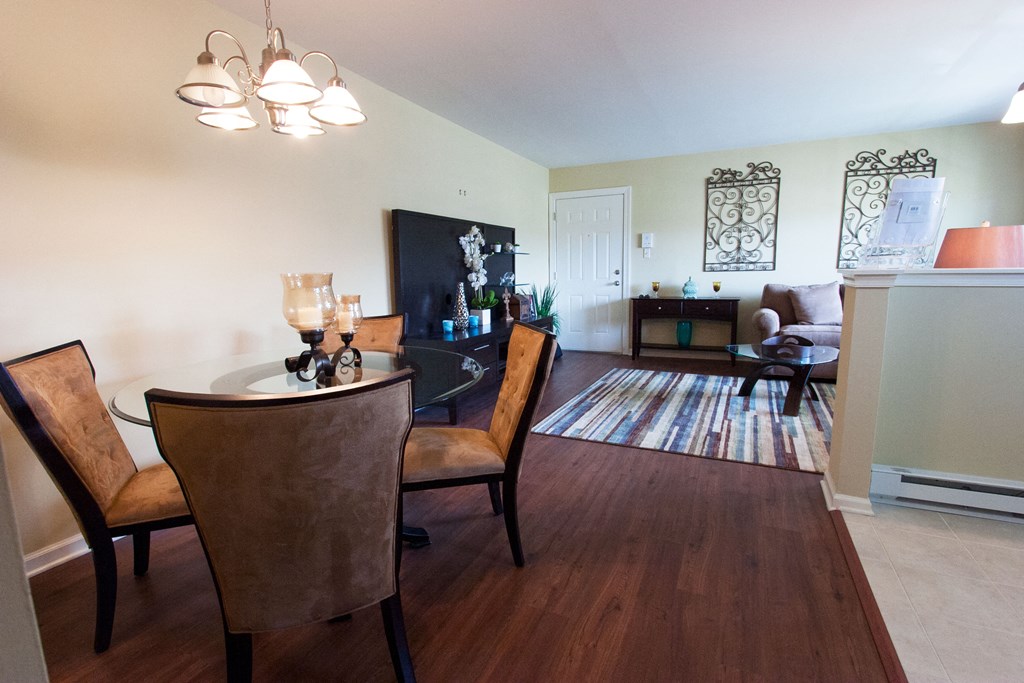 an open living room and dining room with a table and chairs