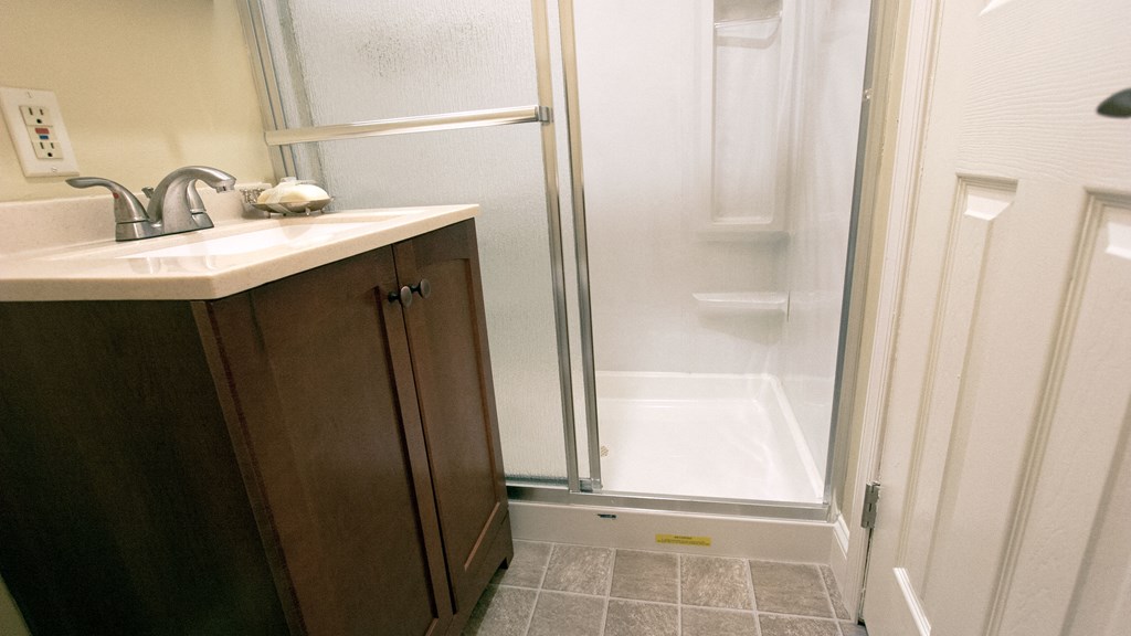 a small bathroom with a sink and a shower