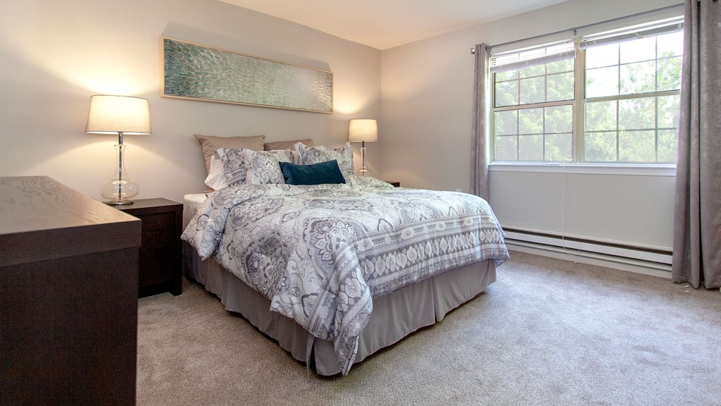 a bedroom with a bed and a window