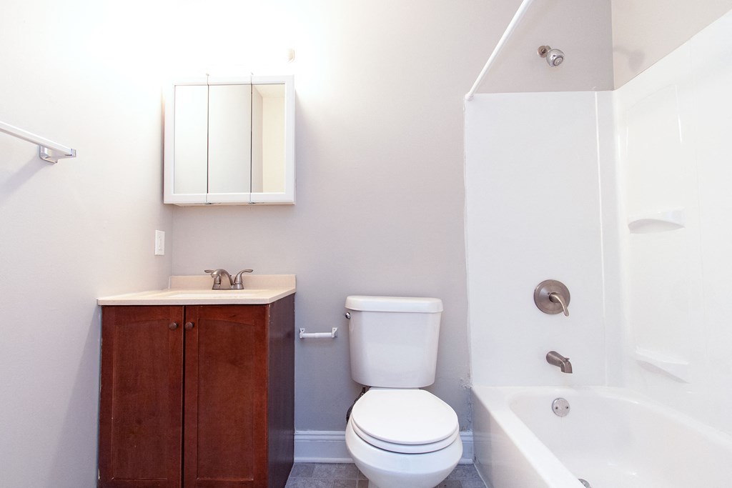 a bathroom with a toilet and a sink and a bath tub