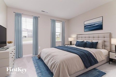A bedroom with a large bed, a television, and a painting on the wall.