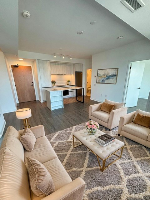 A living room with a white couch and a coffee table.