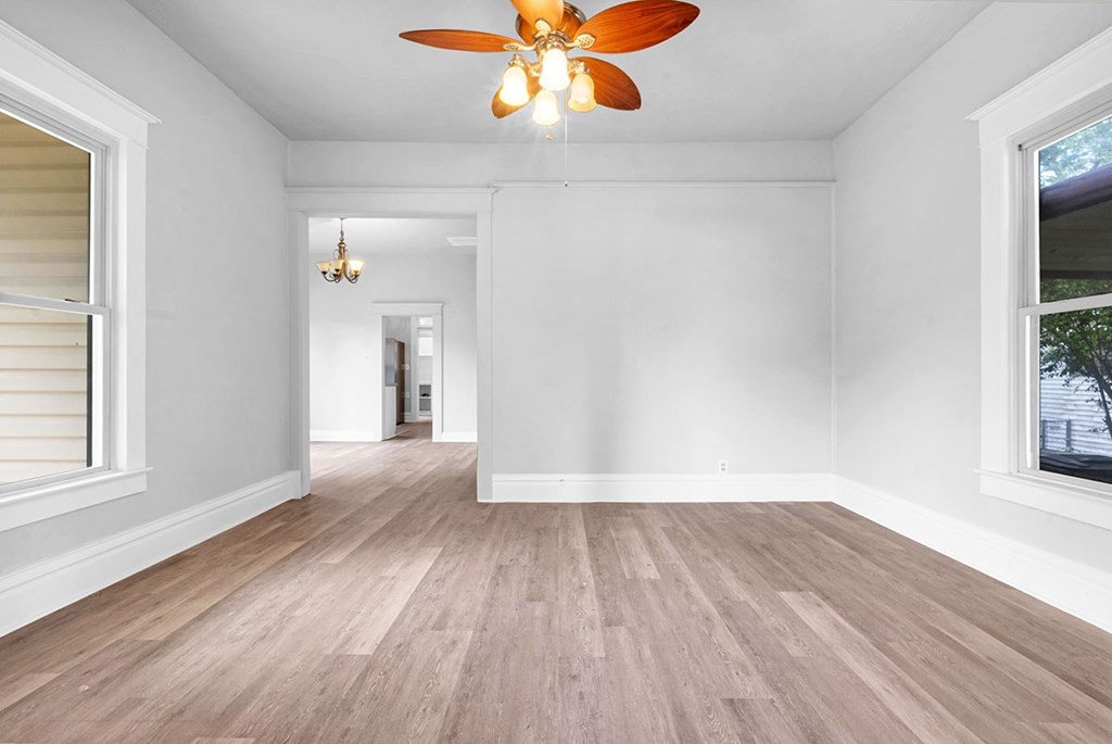 A room with a ceiling fan and light fixture.