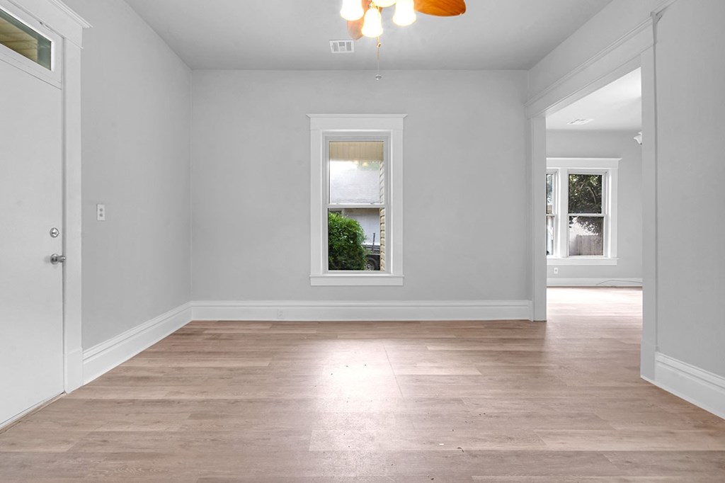 A room with a window and a door.