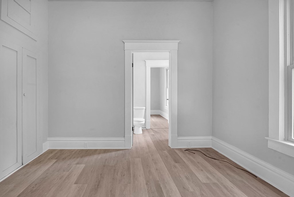 A room with a wooden floor and white walls.