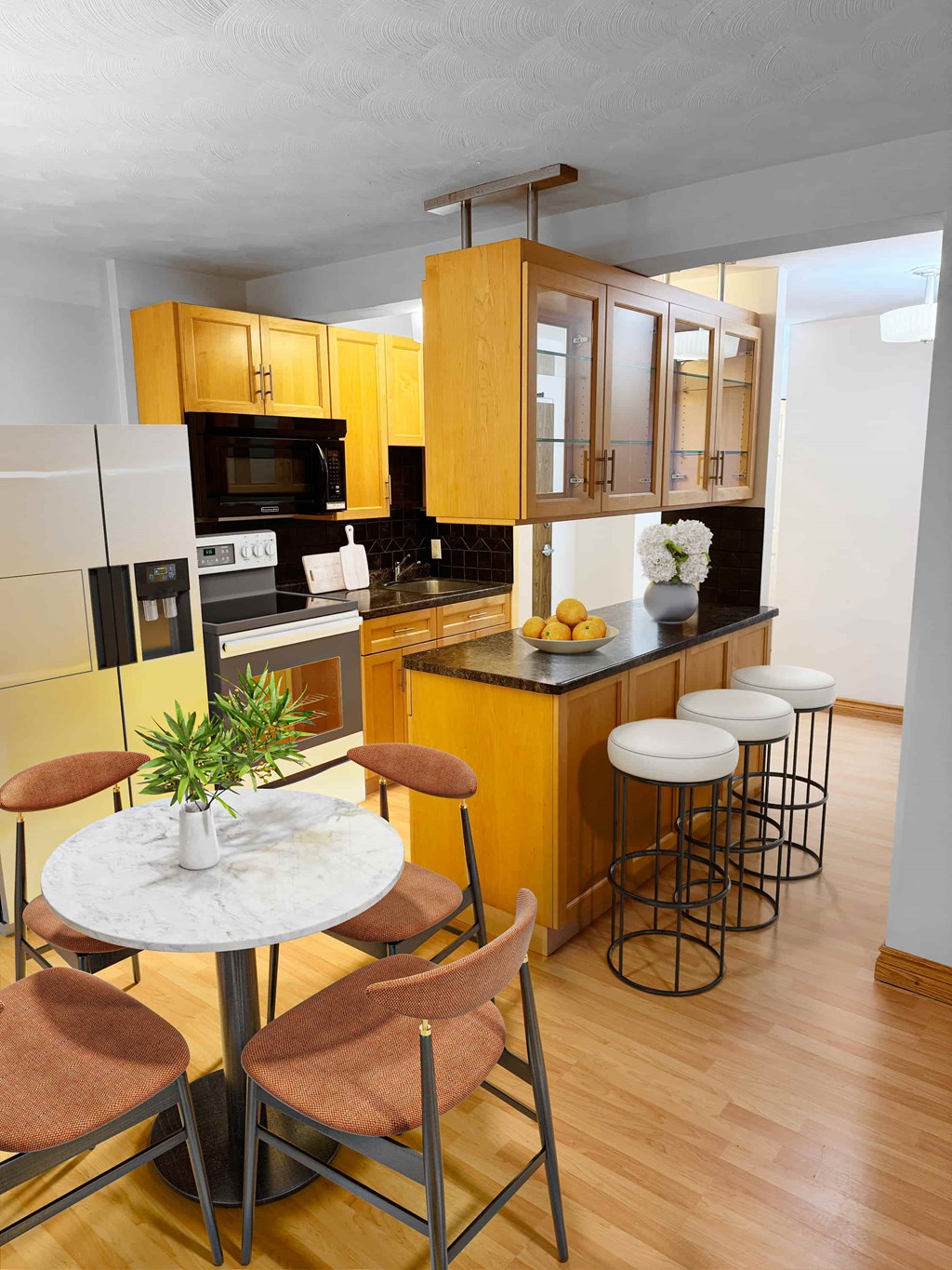 A kitchen with a table and chairs.