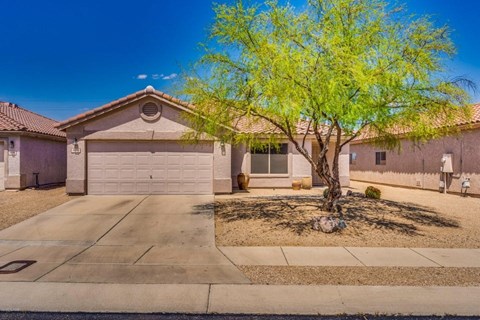 A house with a tree in front of it.
