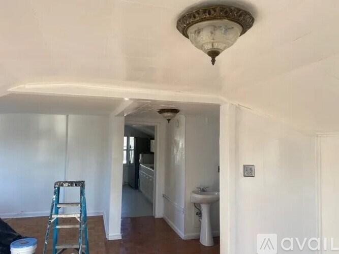 A room with a white sink and a white cabinet is shown.