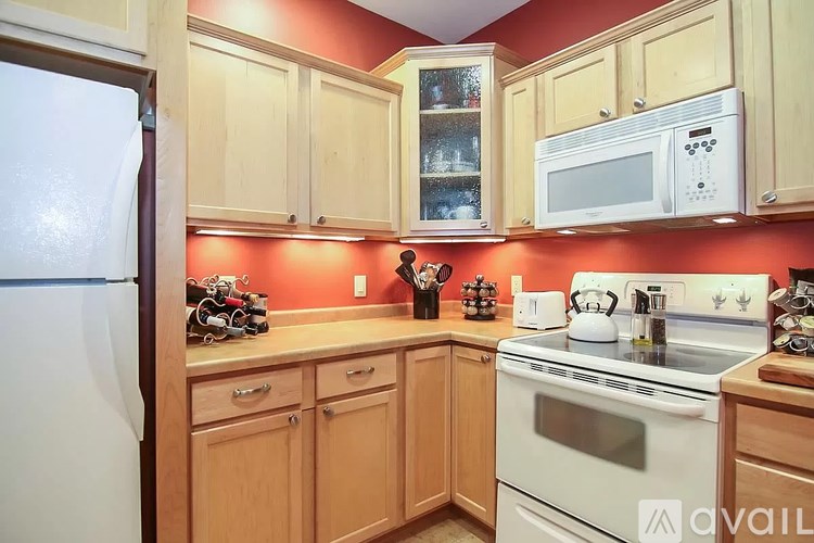 A kitchen with wooden cabinets and a white refrigerator.