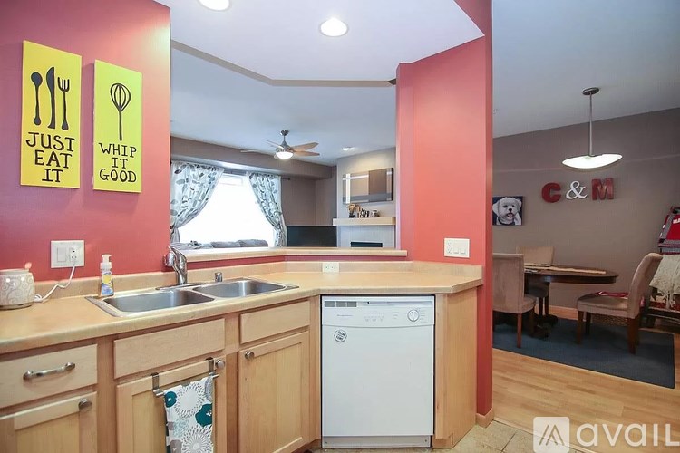 A kitchen with a washing machine and a sink.