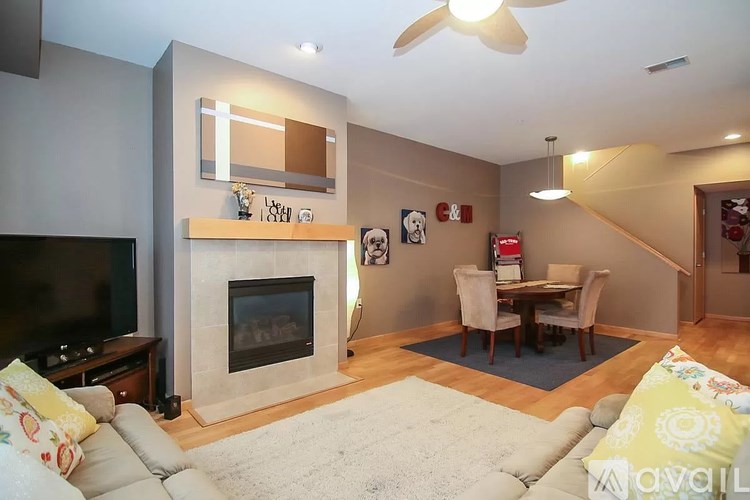 A living room with a fireplace and a television.