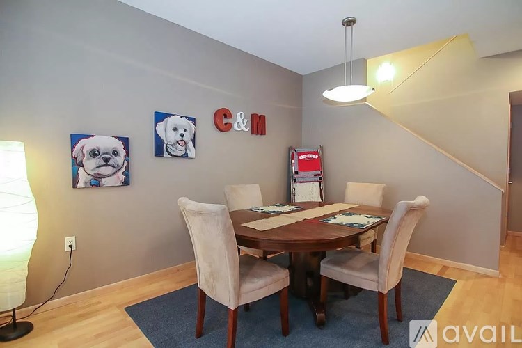 A dining room with a table and chairs.