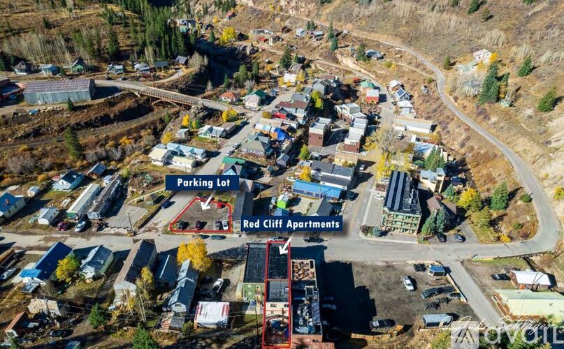 An aerial view of a parking lot and Red Cliff Apartments.
