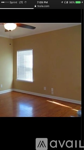 A room with a window and a fan.