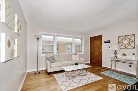 A living room with a white couch and a coffee table.