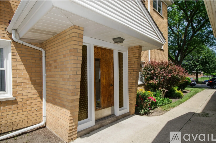 A house with a brown brick exterior and a white door.