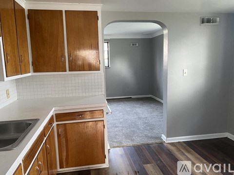 A kitchen with wooden cabinets and a white sink.