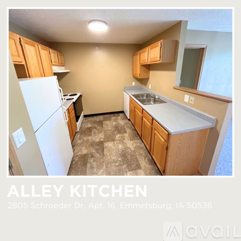 A kitchen with wooden cabinets and a white refrigerator.