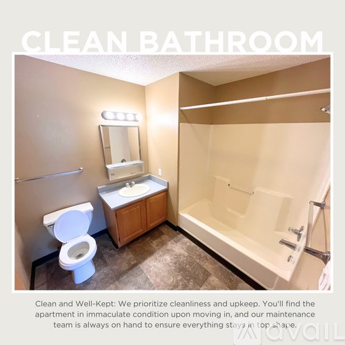 A clean bathroom with a toilet, sink, mirror, and bathtub.