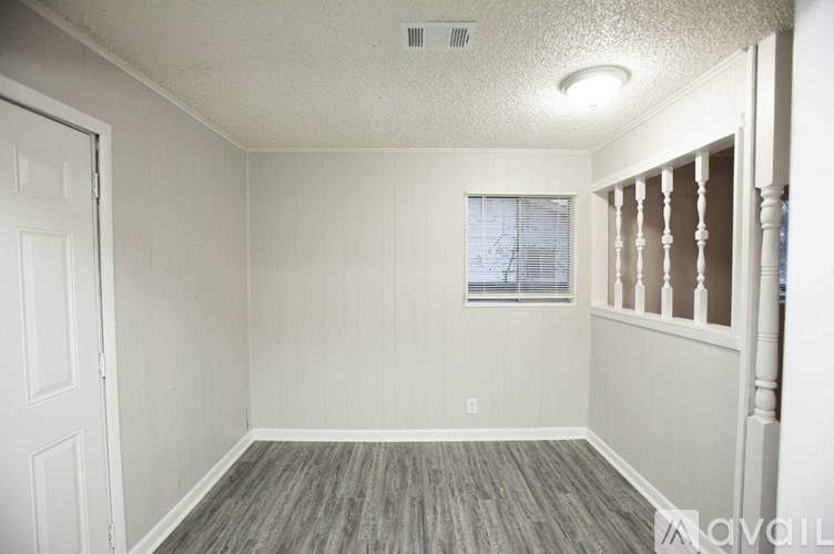 A room with a window and a door.