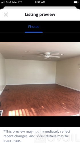 A room with wooden flooring and a ceiling fan.