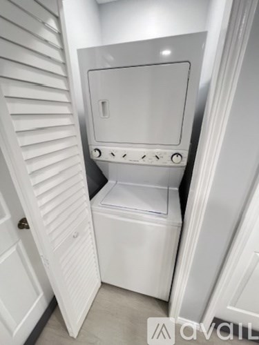 A white toilet with a closed lid is in a small bathroom.