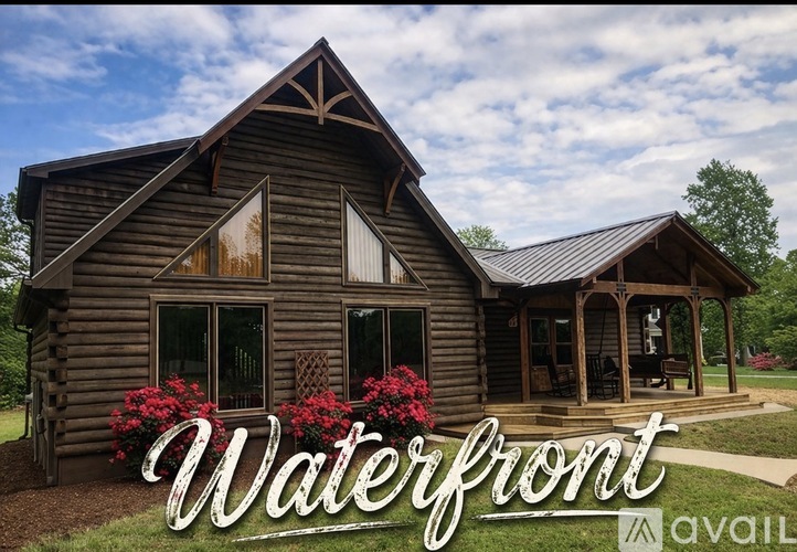 A wooden cabin with a porch and a covered entrance.