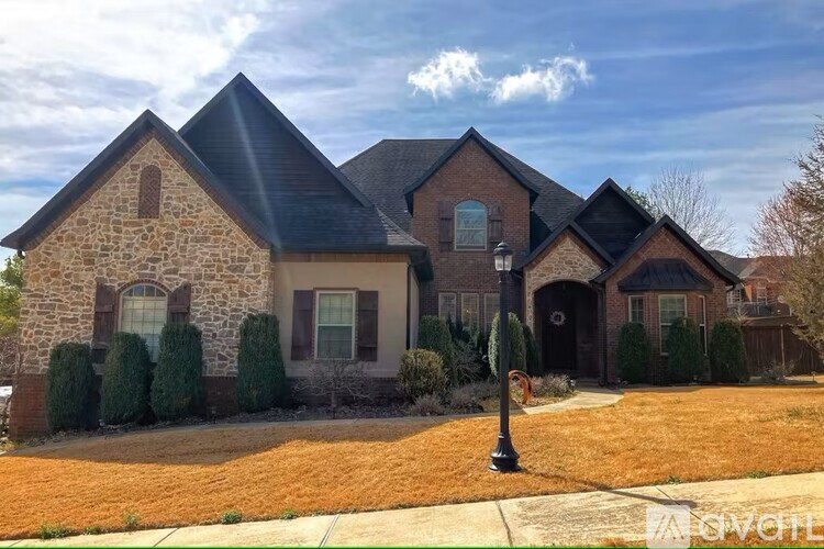 A house with a stone facade and a black roof.